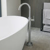 Meir freestanding bath filler beside a white freestanding bath
