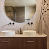 Timber double vanity with round mirrors and Meir wall-mounted black basin mixers