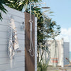 Meir outdoor shower mounted on a weatherboard wall
